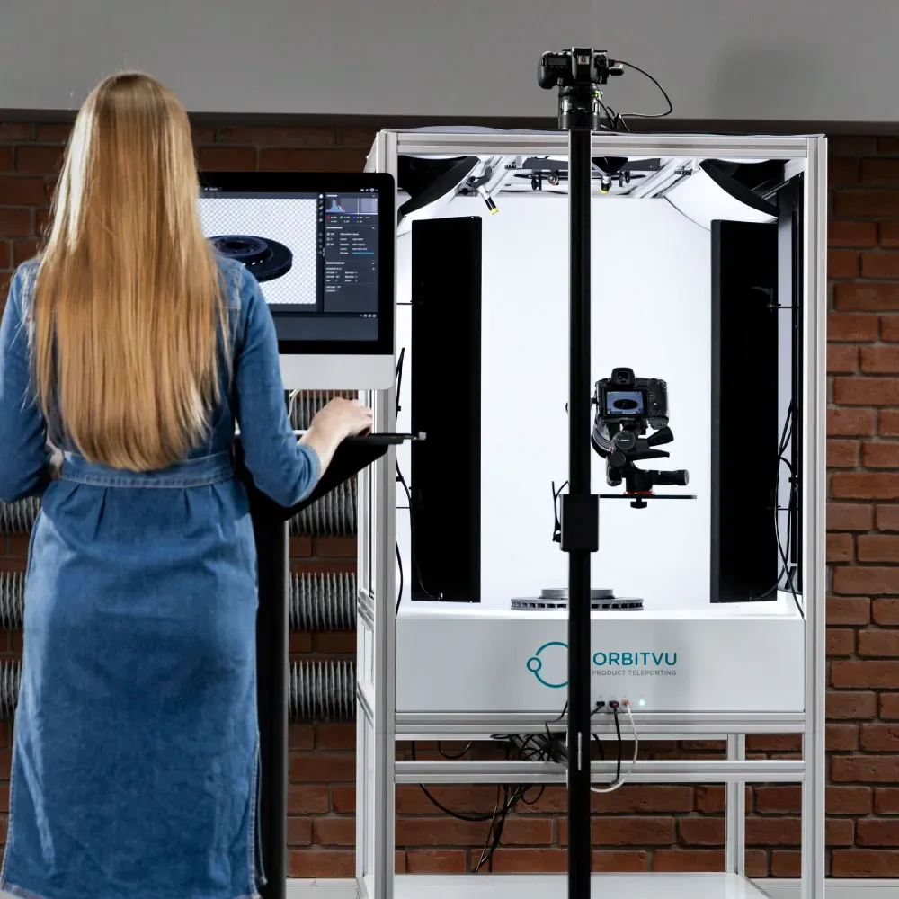 Woman operating Orbitvu photostudio setup