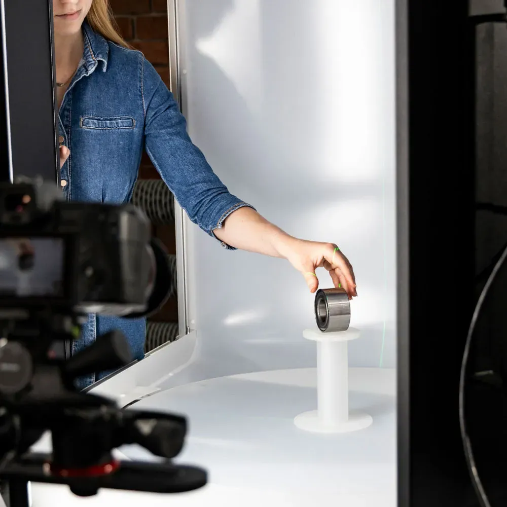 Placing product in photography lightbox studio